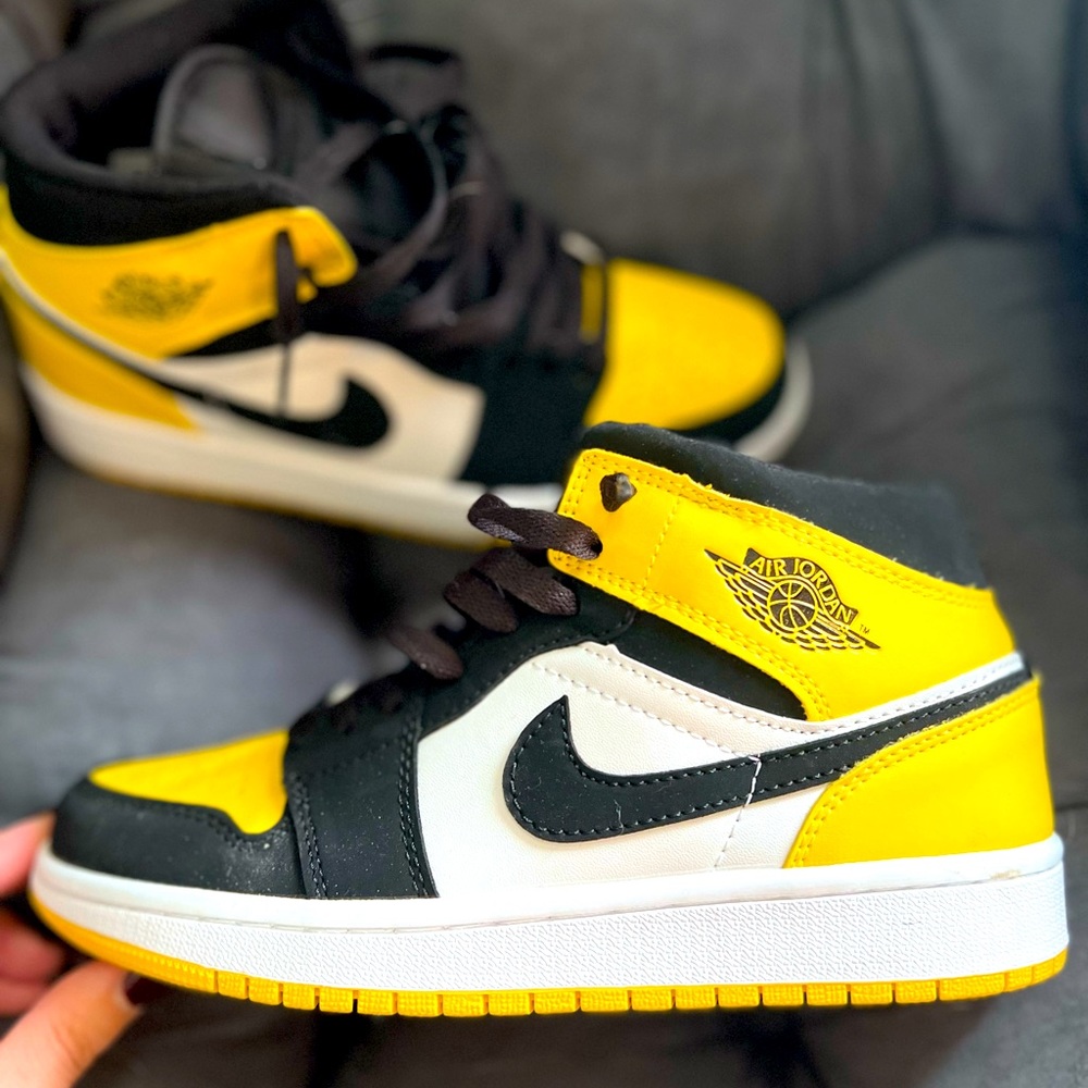Black, gold, and white Nike Air Force